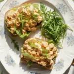 Separated ingredients for Buffalo Chicken Salad including cooked chicken, mayo, and buffalo sauce.