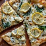 Delicious Whole Wheat Spinach and Artichoke Pizza with lemon and pine nuts.