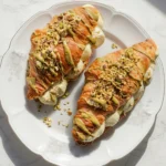 A filled Pistachio Croissant with green nut cream.