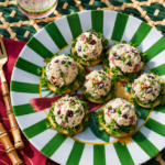 A bowl of golden Chicken Salad With Apples with cranberries and almonds.