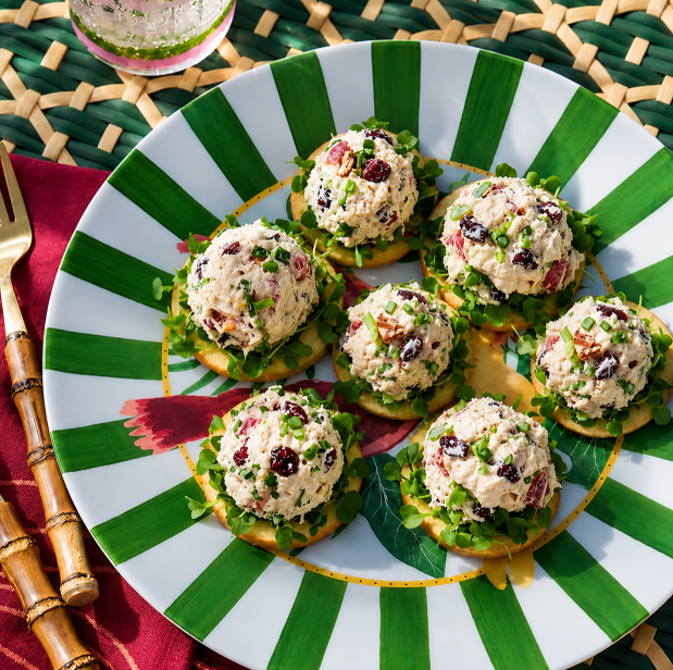 A bowl of golden Chicken Salad With Apples with cranberries and almonds.